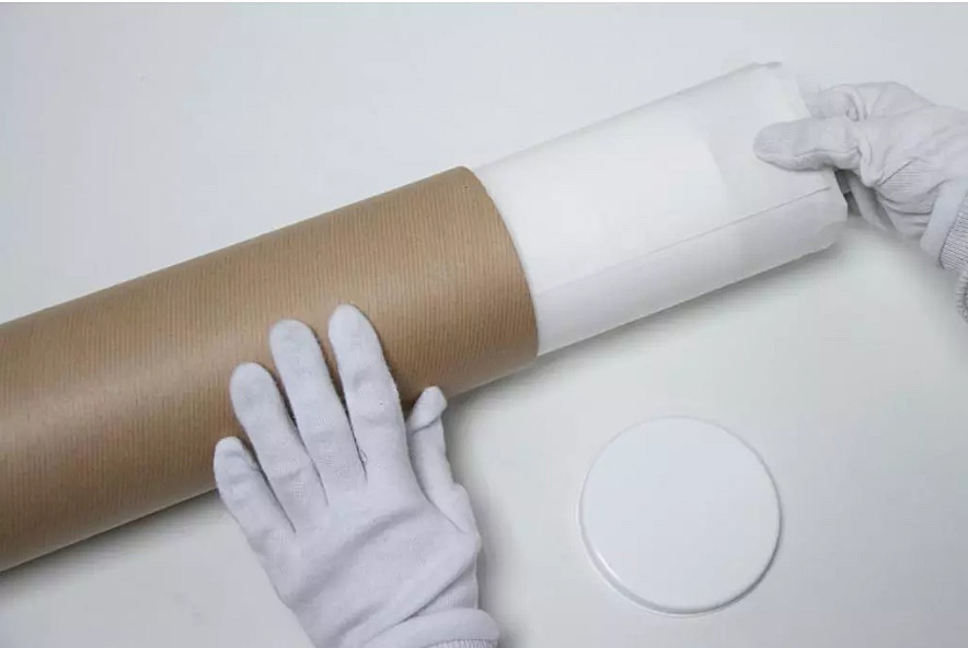 Tissue-wrapped prints are despatched in a postal tube